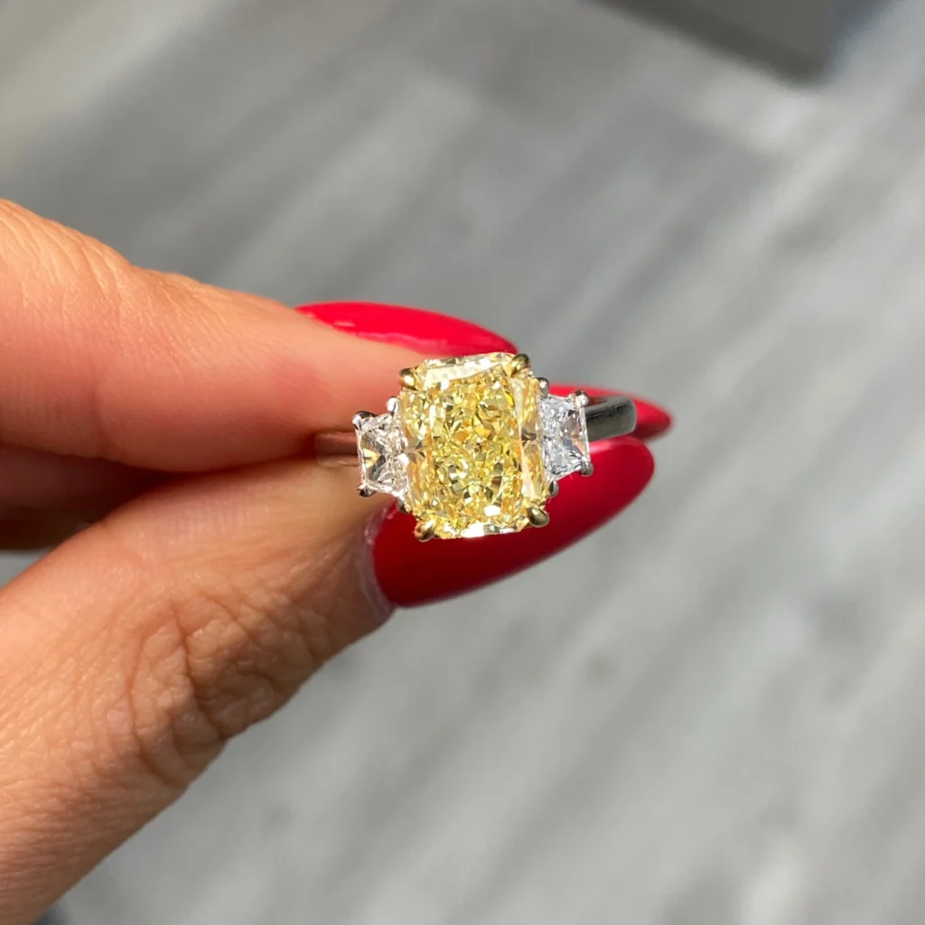 Alternative view of 3 Carat Fancy Yellow Elongated Radiant Diamond Three Stone Ring